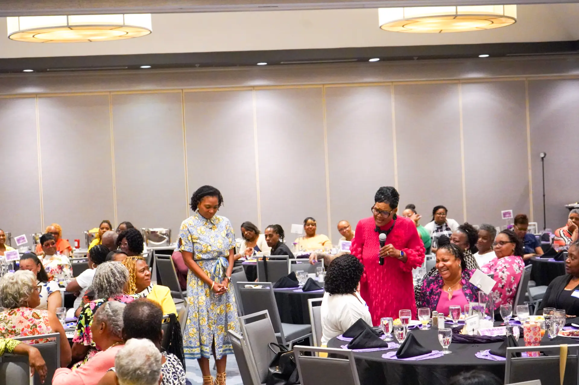 Dr. Lucretia Mason-Underdue speaking to a ballroom of women