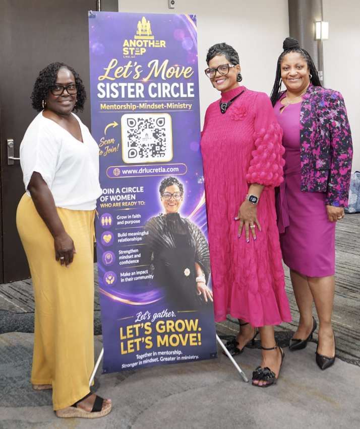 Dr. Lucretia with two women beside the Let's Move Sister Circle banner